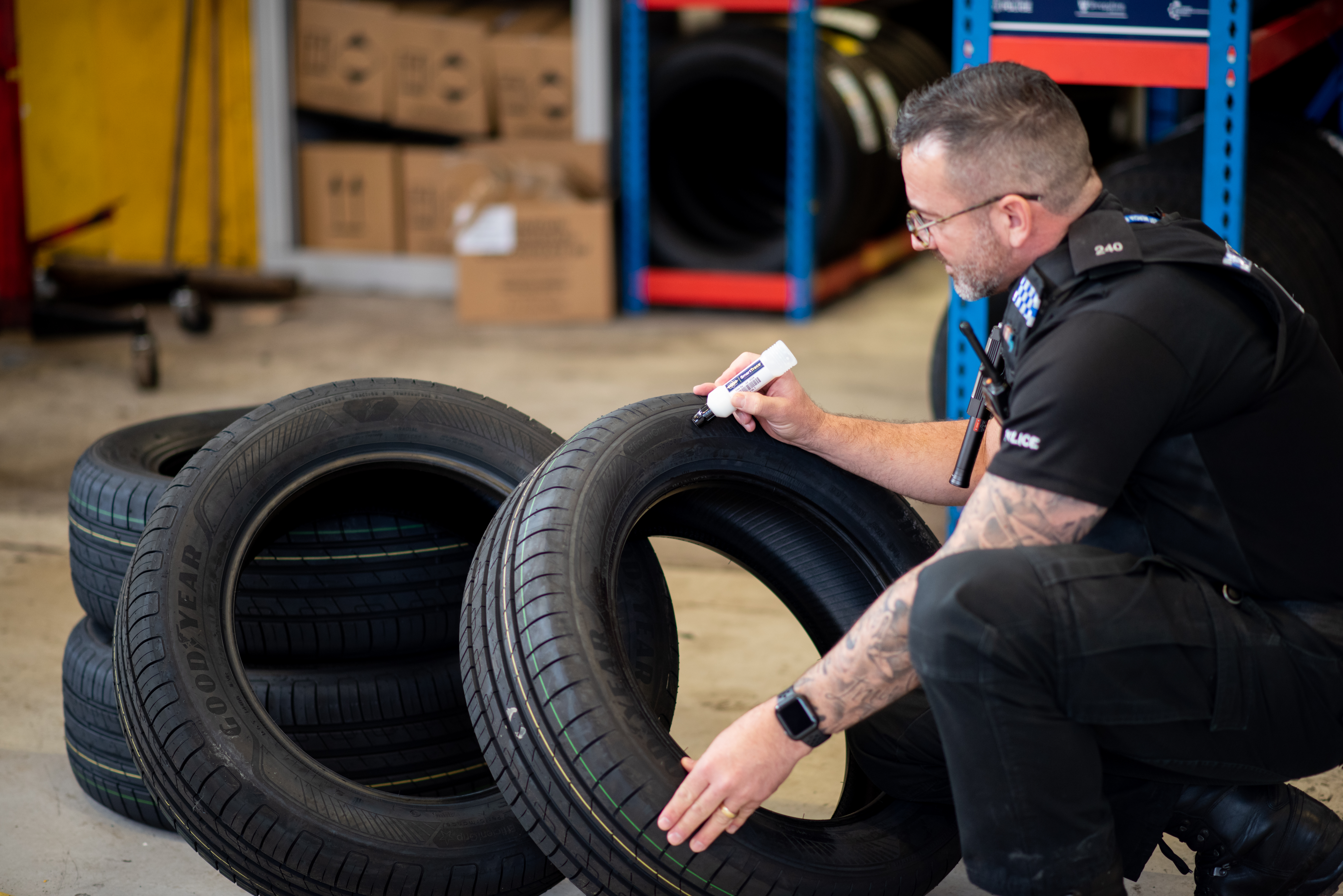 Officer marking tyres using the Smartwater kit