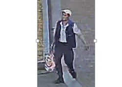Man in white hat carrying a bag