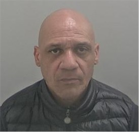 Mixed race man with bald head wearing black jacket