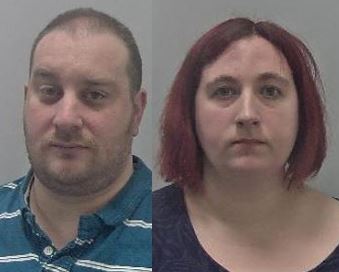 Man with shaven head and woman with purple hair