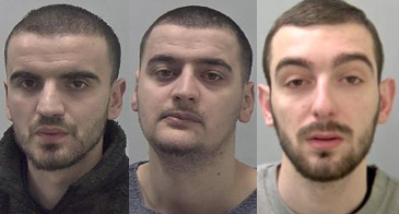 Three men with dark shaven hair