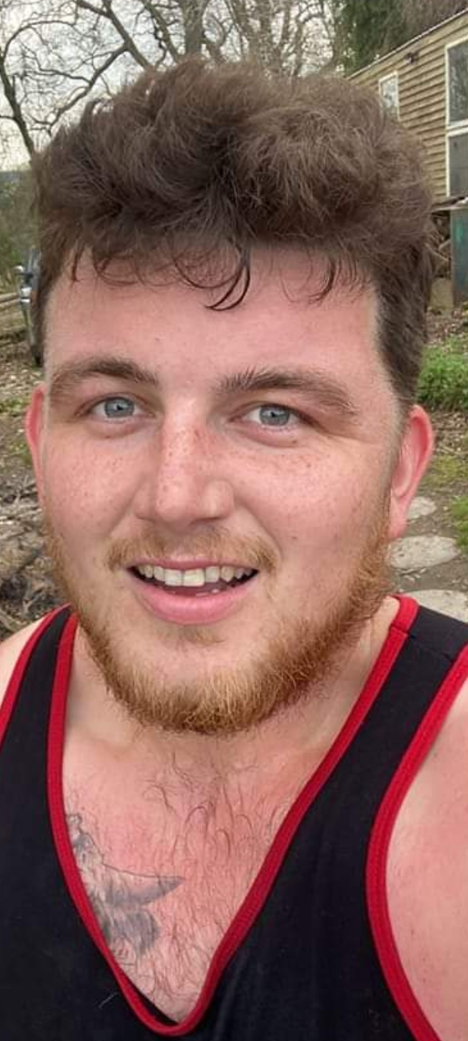 Smiling man with blue eyes and stubble