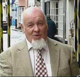 Man with short grey hair and grey beard