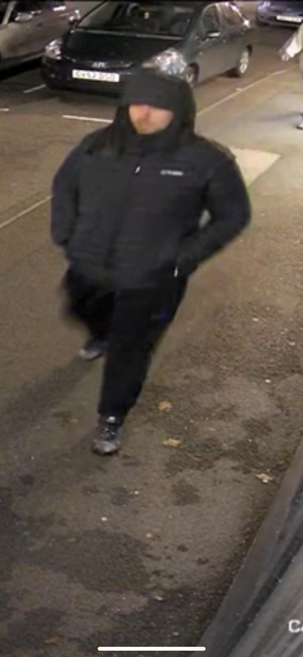CCTV image of man officers would like to speak to about a robbery in Evesham. Man is white and wearing a black hooded coat and black trousers