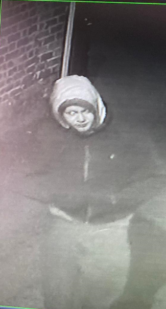 person wearing a grey hoody and dark coloured jacket 