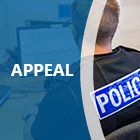 Back of a police officer at a computer with a blue overlay and the word appeal