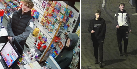 One man with blonde curly hair and goatee beard, second man dressed in black with hood up