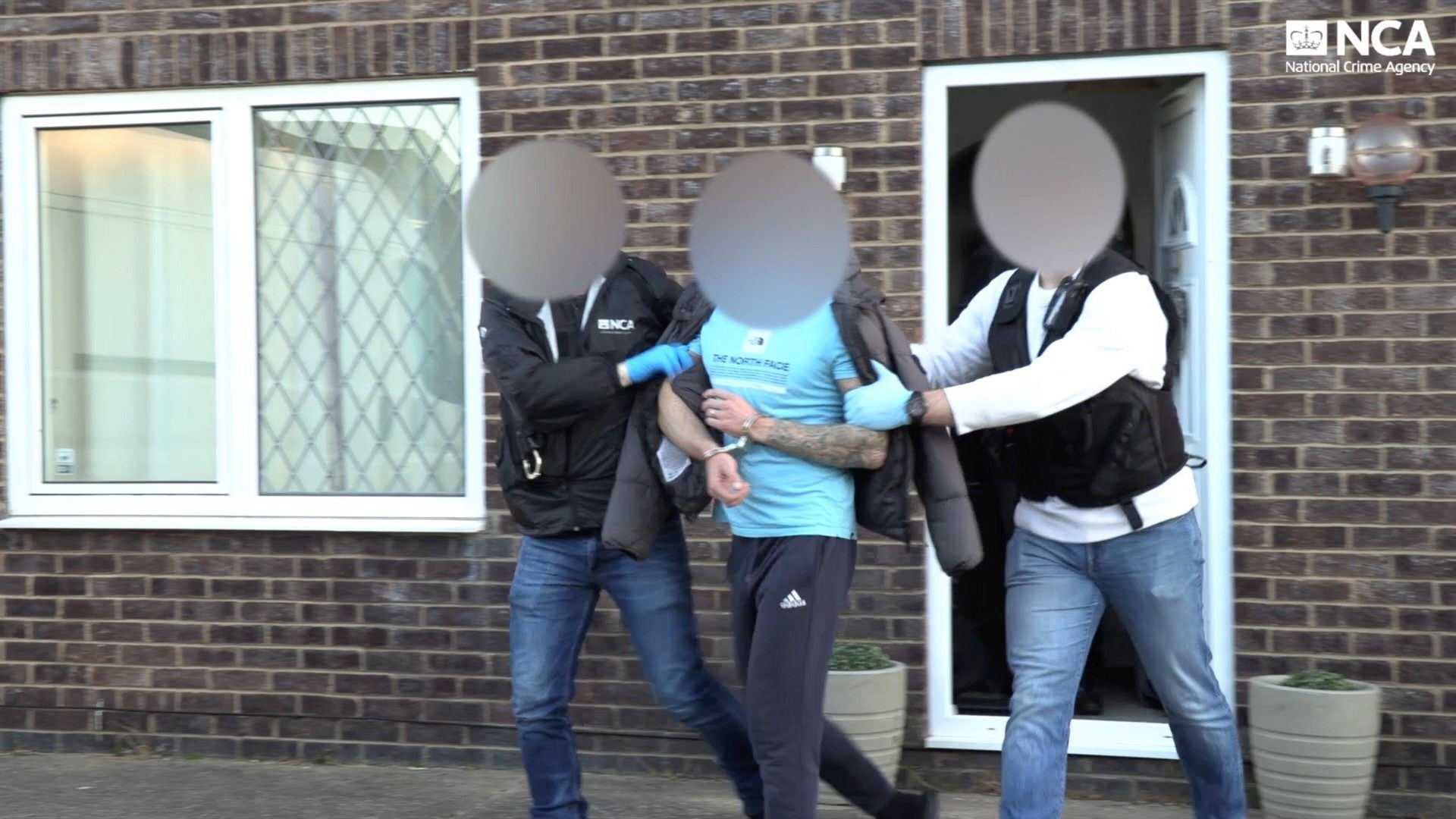 Two officers arresting an offender