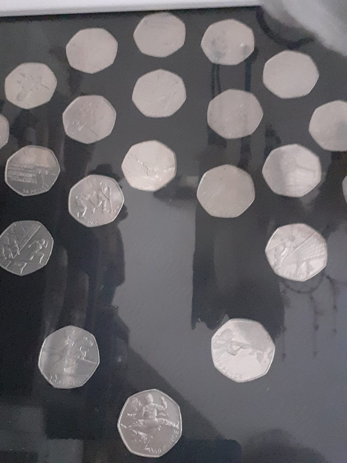 WA1 &ndash; Photograph of the photo frame hung by the front door containing 50p coins.jpg
