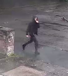 man dressed in black wearing a hoody 
