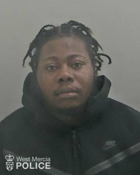 Young black man with dreadlocks, wearing a black hoody