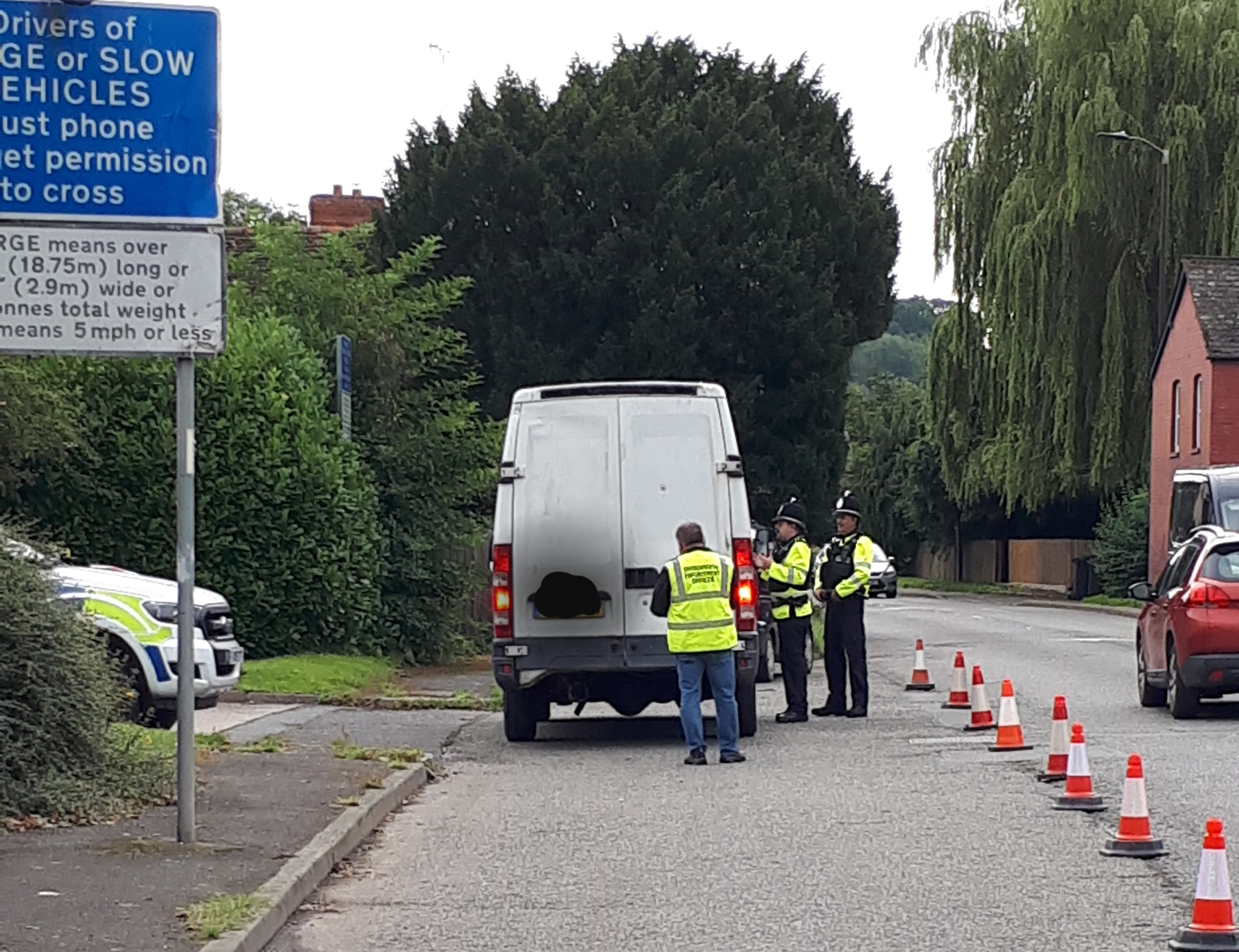 Police officers by a parked van