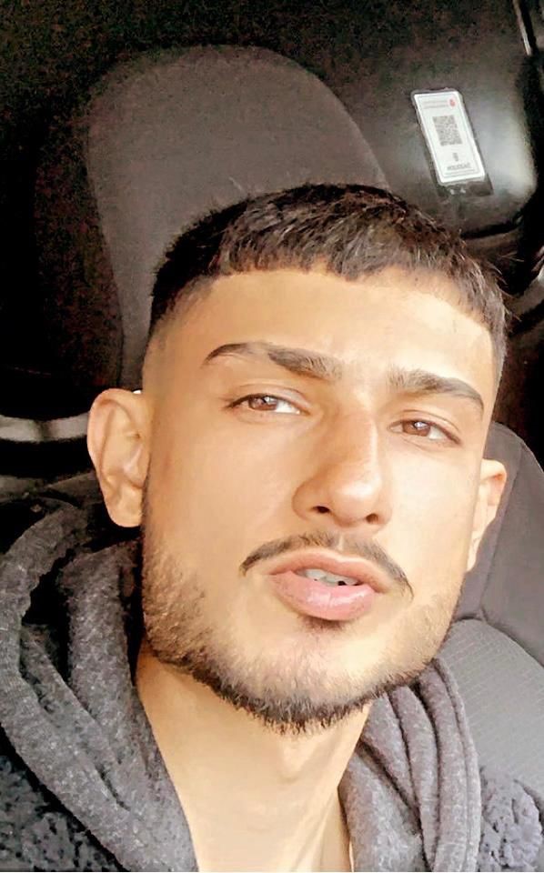 Asian man with facial hair looking at the camera 