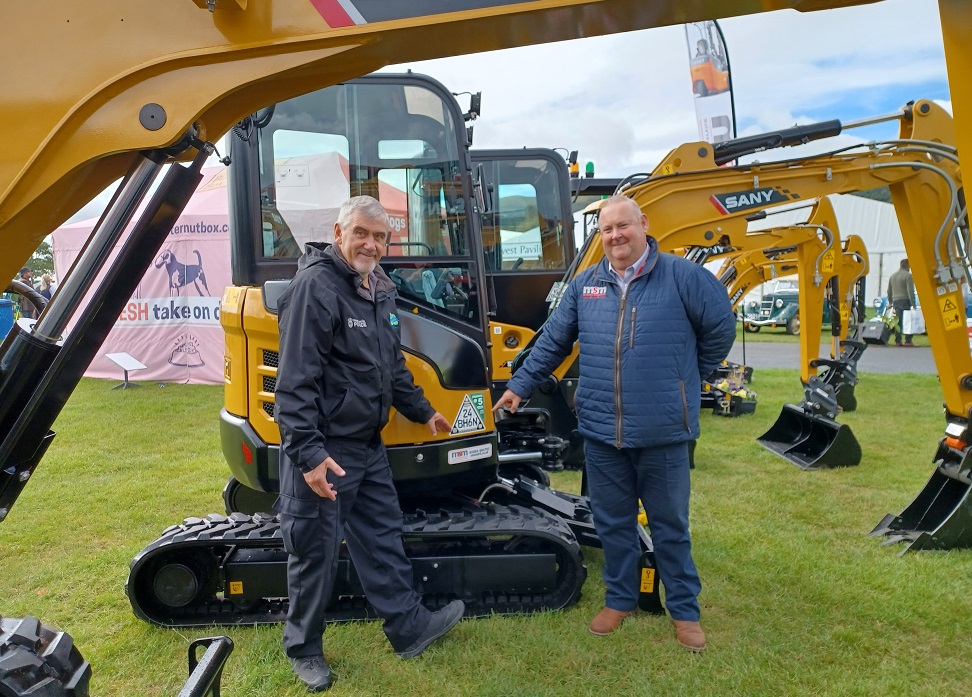 A rural crime officer and a trader at the Malvern show with diggers around them