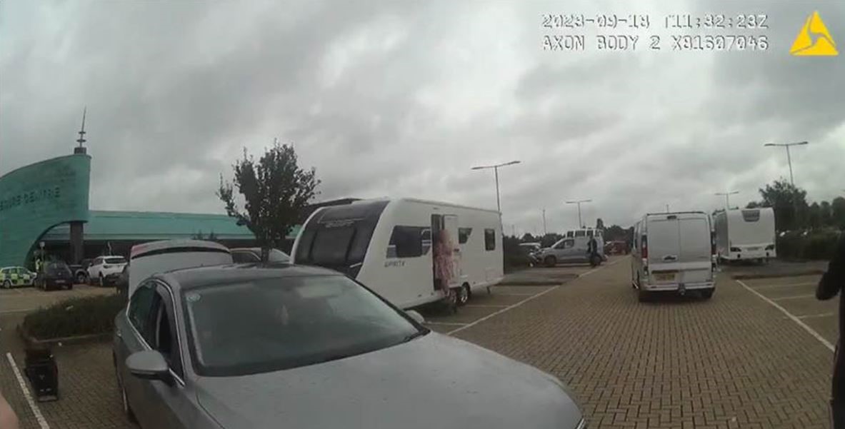 Body worn camera still of travellers on a car park