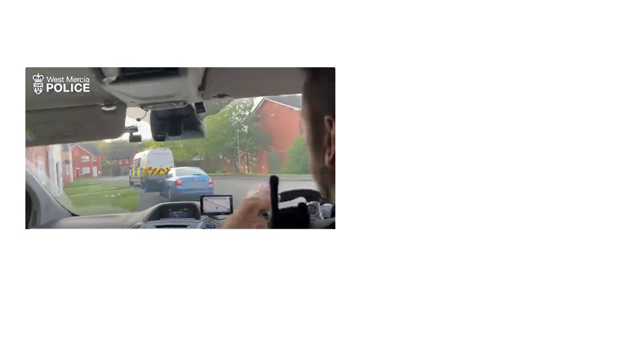 Photo of inside the police car with two police cars in front 