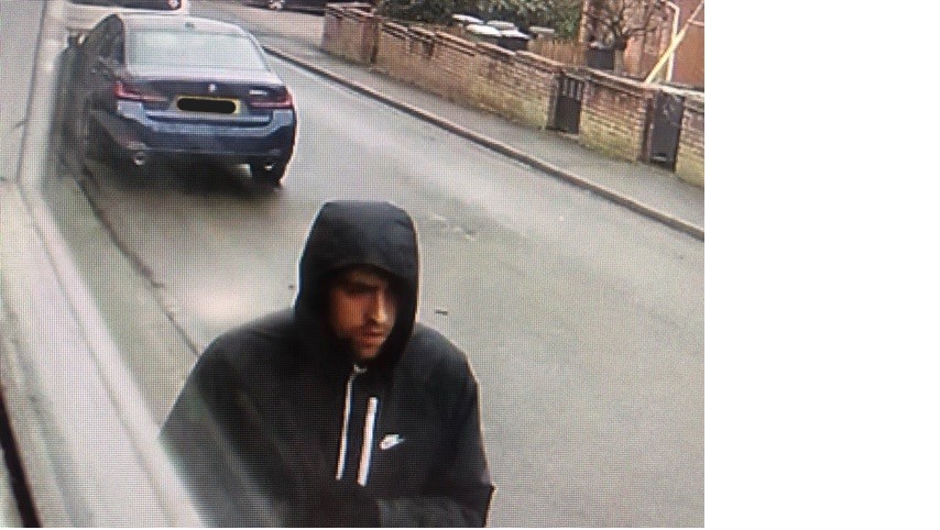 Man with nike hoody on walking down the road 
