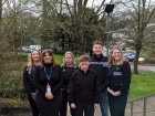 A group of officers wearing standing outside