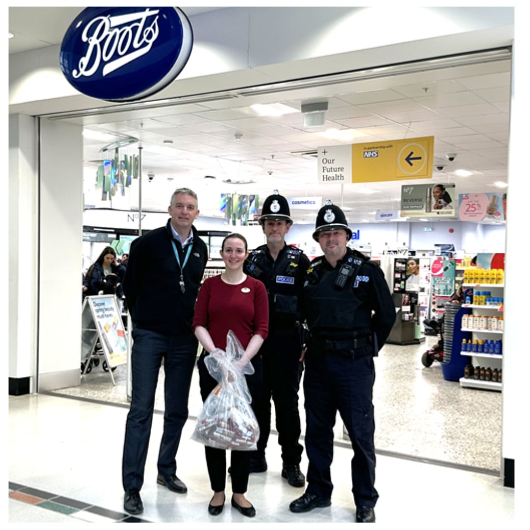 Adrian Field, General Manager of the Kingfisher Centre and Laura Burberry, manager of Boots, with Police Constable Mike Moore and Police Sergeant David Roberts of Redditch SNT. 