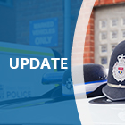 Police hats on roof of car, blue overlay with update