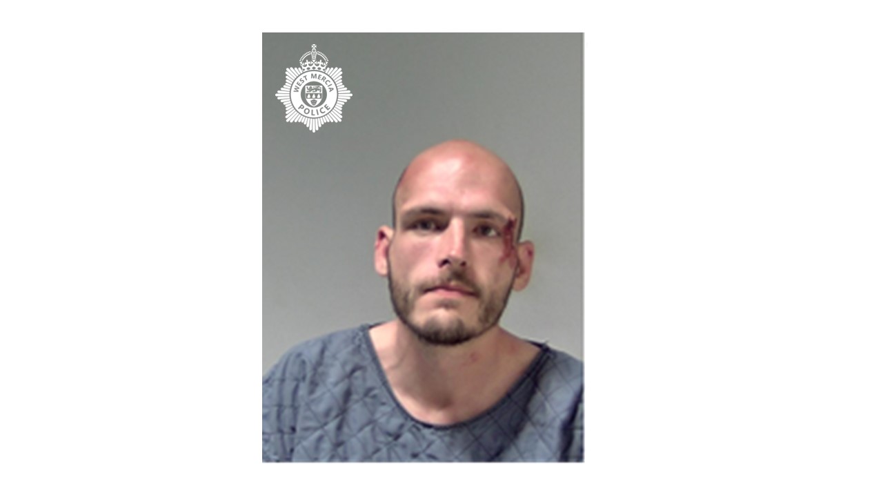 Custody image if a man with police logo 