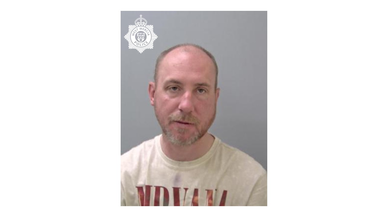 Custody image of man with grey facial hair 