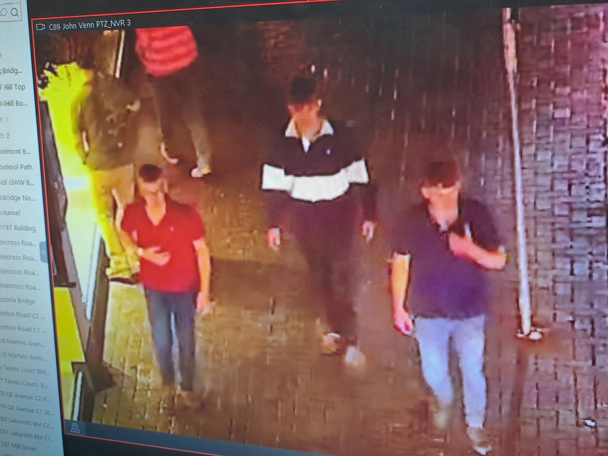 3 men walking along street