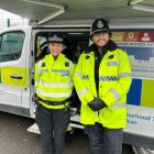 Two police officers smiling.