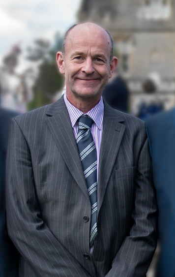 White man, wearing a grey suit. 