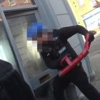 Officer forcing entry into a barbershop.