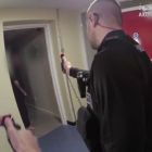 Police officers point their PAVA spray towards a person with knives in their hand