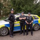 Special Constables standing next to a police vehicle
