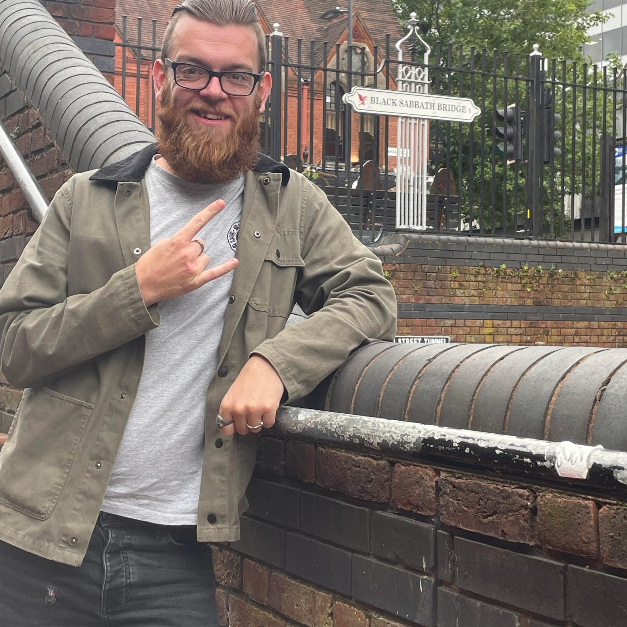 31 year old Joe Millard standing on black sabbath bridge
