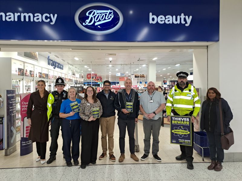 Officers and Boots staff outside Boots in Telford 