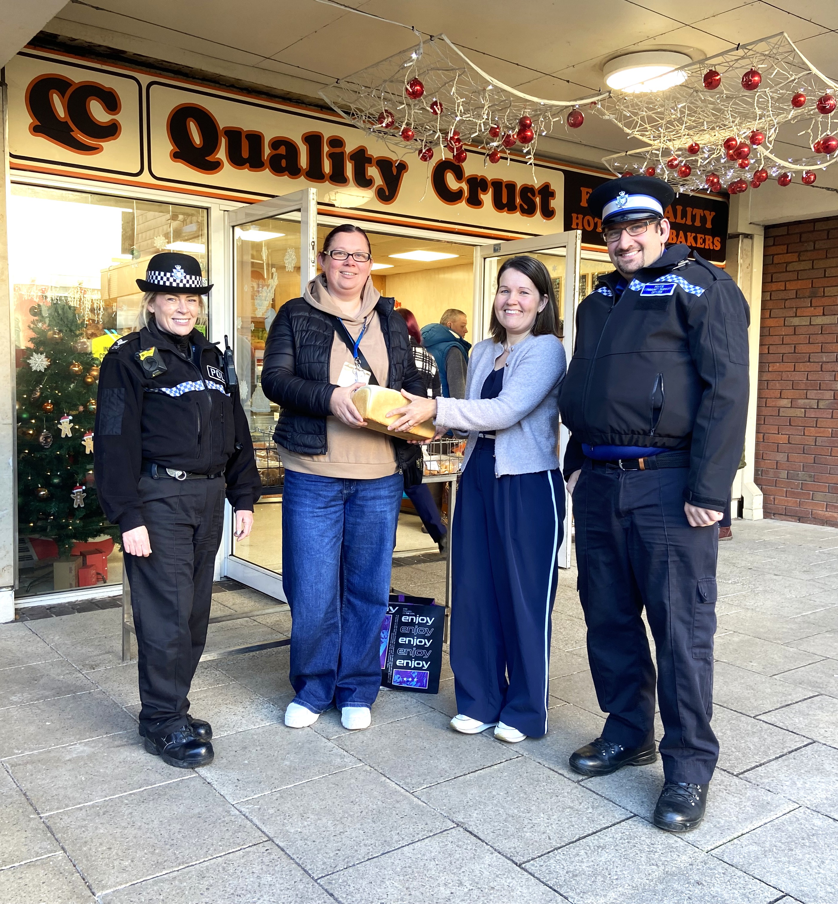 Two police officers and two woman outside a bakery in Droitwich.
