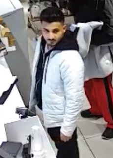 Asian male with dark back hair and wearing a white coat. 