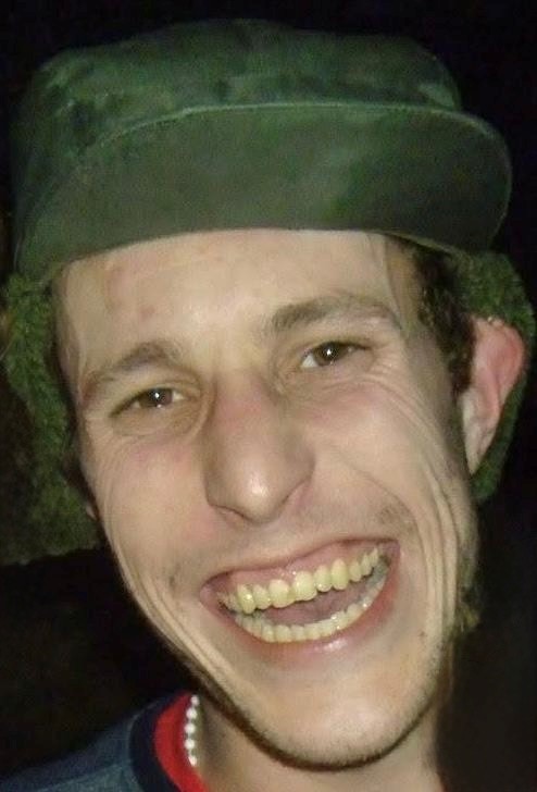 image of man smiling wearing a green hat