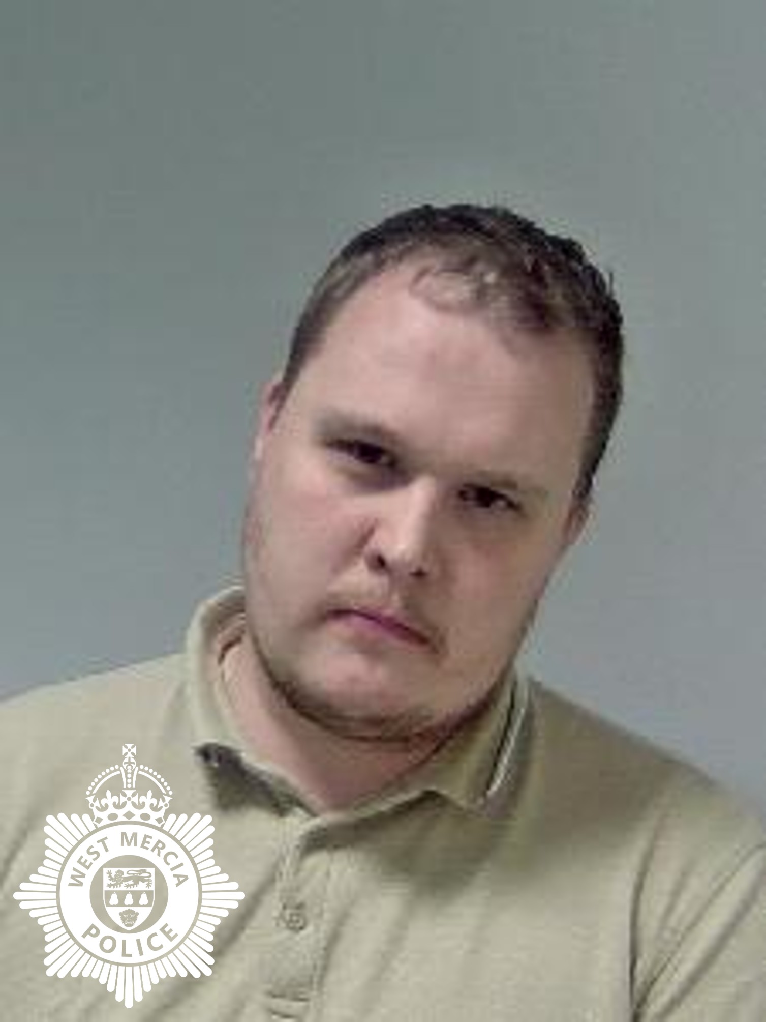 custody image of white man wearing a cream polo top with facial hair