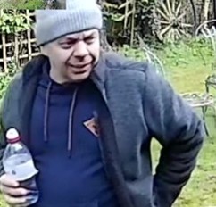 Man wearing grey hat, with blue jumper and blue jacket. 