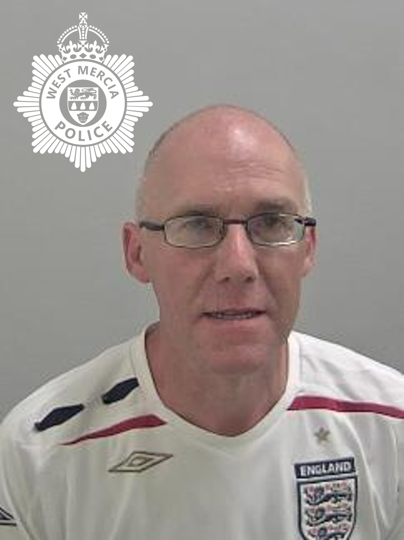 custody image of white bald man wearing an england football shirt