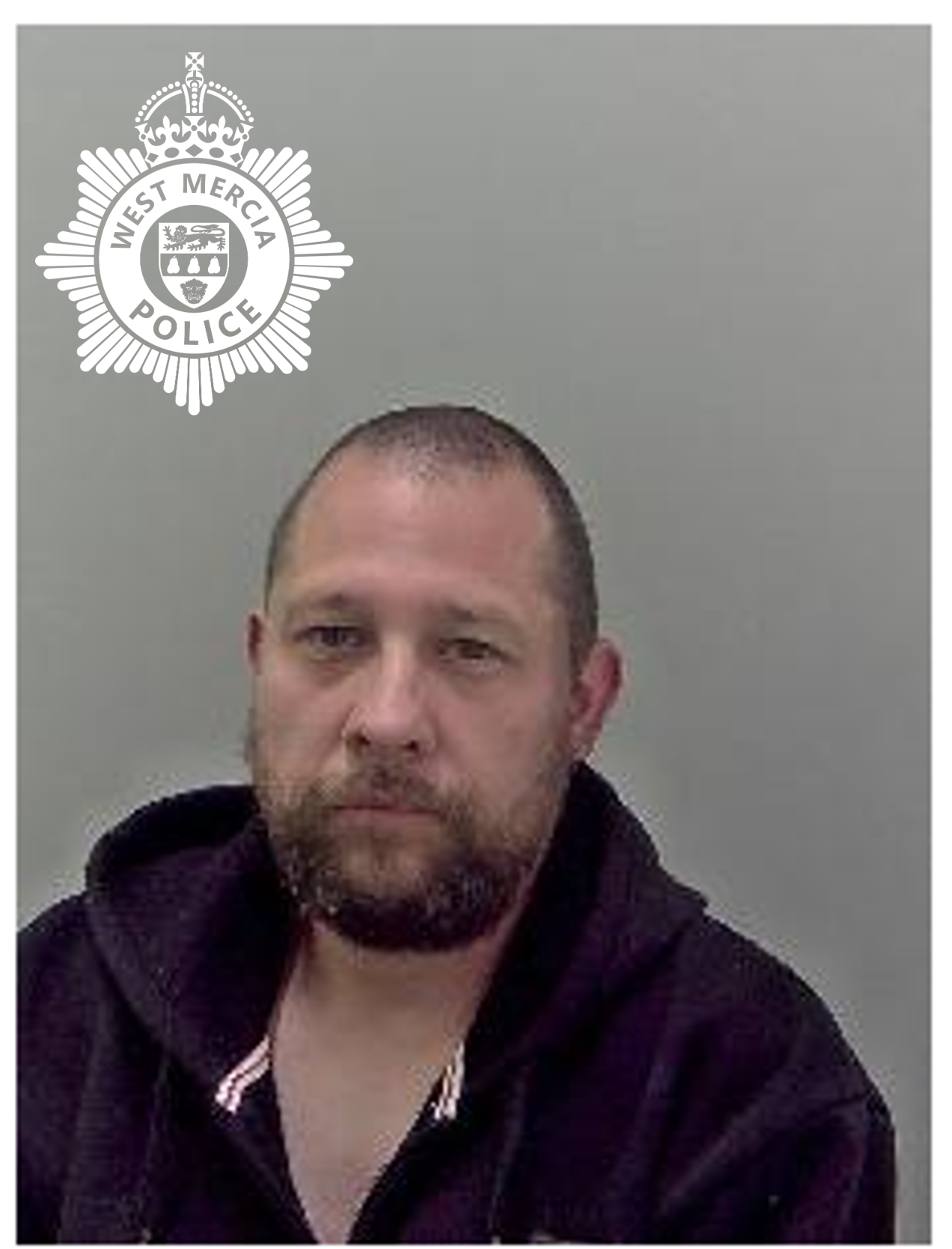 custody image of white man with balding hair wearing black hoody