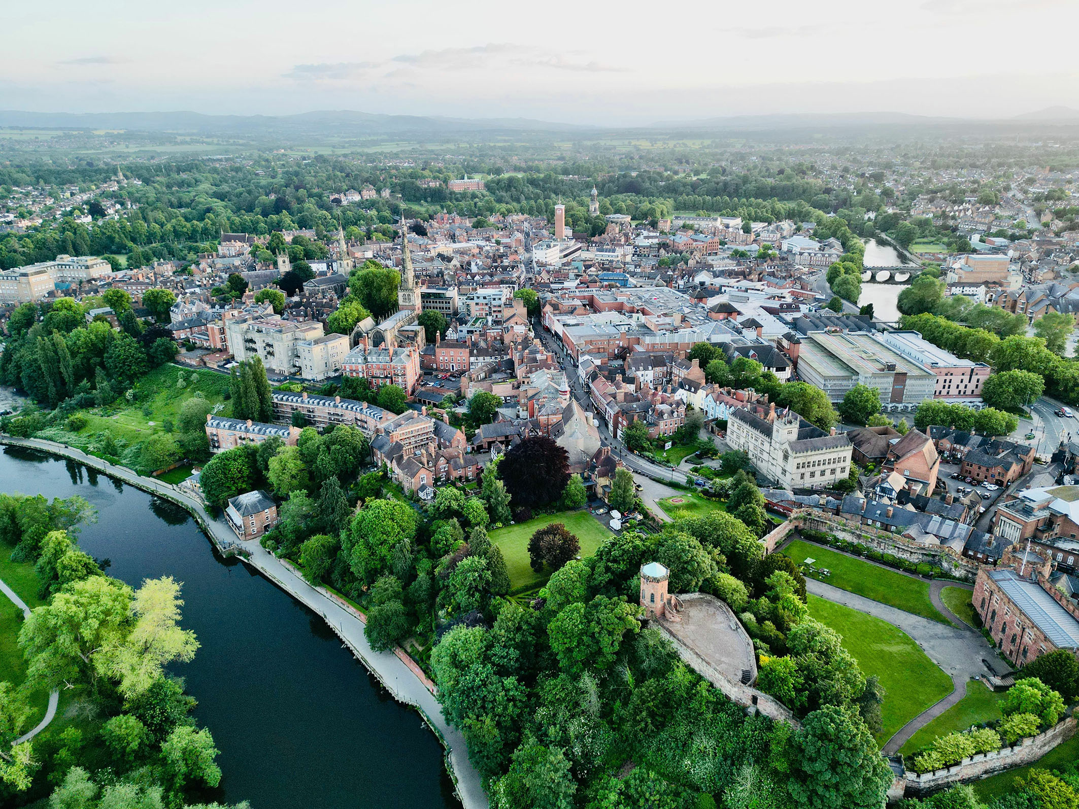 aerial view of shrewsbury town with the river, buildings and lots of greenery