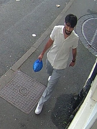 Brown male, with dark hair and wearing a white shirt. 
