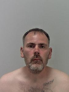 White male, short black hair and white stubble. 