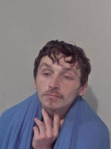 White male, brown hair and has a blue blanket around him.