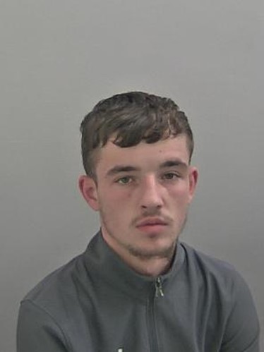 White male, 19 years old, short brown hair, wearing grey t shirt.