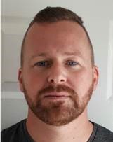 man with short brown hair and beard 