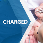 Charged - a man in handcuffs