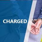Charged title with person in handcuffs photo 