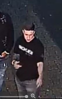 White male, aged between 18-25, slim build with short black hair.